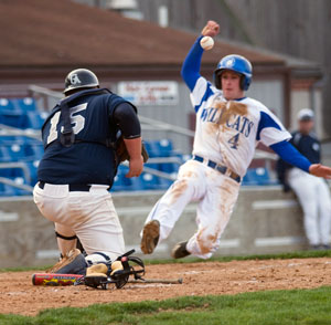 Phil Woodring slides to beat the tag during doubleheader action April 14.