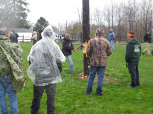 John P. Gildea chops his way through the Pole Fell, supported by teammates Michael J. McGrady (in orange bandanna) and Brian A. Tomassacci. At left are co-advisers Jack E. Fisher (in camouflage) and Erich R. Doebler.
