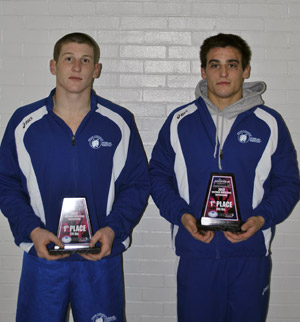 Logan Gresock (left) and Derek Leiby hold their plaques after finishing first in their respective weight classes.