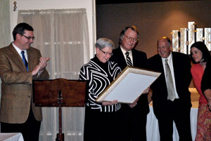 President Davie Jane Gilmour looks at a plaque prepared by graduating students, joined (from left) by Elliott Strickland, interim chief student affairs officer%3B William J. Martin, senior vice president%3B Dennis L. Correll, associate dean of admissions and financial aid%3B and Valerie A. Baier, administrative assistant to the president.