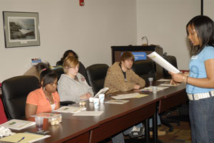 A volunteer from the AmeriCorps Community Connect chapter leads participants in a session to consider resources for helping alleviate a community problem.