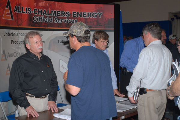 Allis Chalmers Energy representatives field questions from a steady flow of visitors.