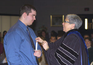 Penn College President Davie Jane Gilmour pins Edwin Weaver, signifying his induction into Alpha Chi.