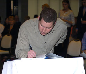 Phillip J. Hoffmaster signs the official Alpha Chi registry.