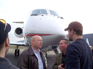 Altria's John Davis (second from left) talks with Brett A. Reasner, associate professor of aviation, as former intern Rich Geyer (left) and student Greg Gilliland look on.