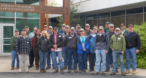 Four decades of forestry graduates are represented in an alumni group photo.