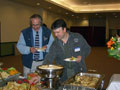 Tom Gregory, dean of construction and design technologies, joins Frank Nestico (class of '92) at the buffet line