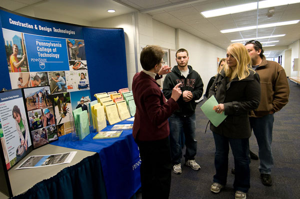 Anne K. Soucy, assistant dean of construction and design technologies, answers questions near the school's informational display.