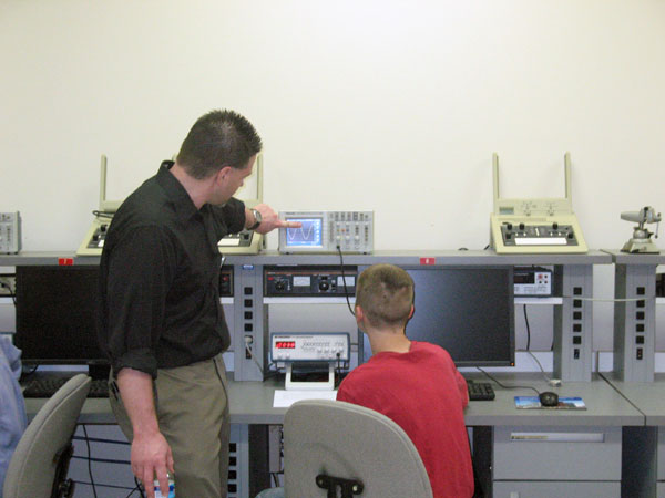 Art Counterman, electrical technology/electrical occupations instructor, shows a student how to use an oscilloscope during his Introduction to Microcomputers activity session.