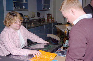 Student Wendy L. Frew, left, discusses her work with graduate Joe Tertel, now an e-marketing specialist for JPL Productions.