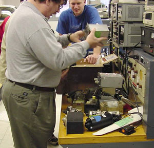 Thomas D. Inman, associate professor of avionics, and Jason M. Smith, a senior majoring in aviation maintenance technology, unpack donated equipment.