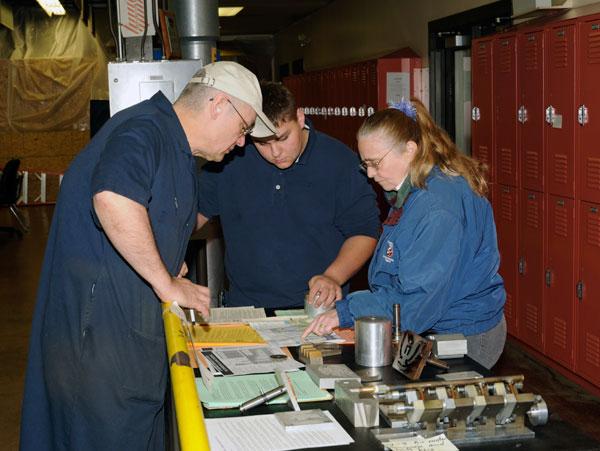 Thomas J. Livingstone, associate professor of machine tool technology/automated manufacturing, meets with visitors to the School of Industrial and Engineering Technologies.