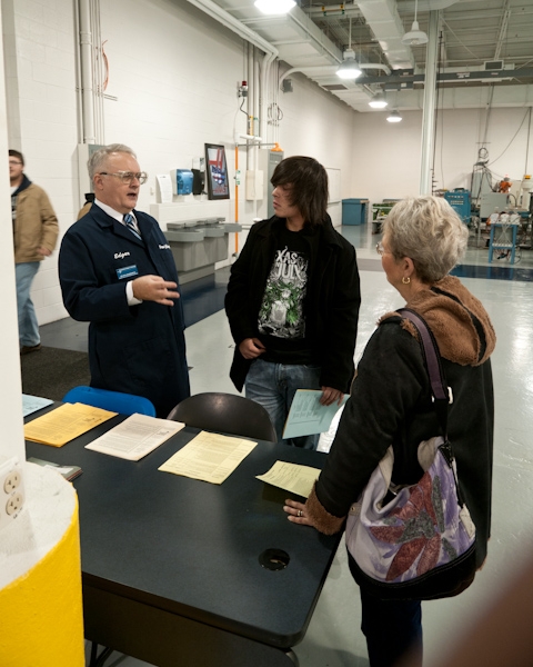 Ed Hollingsworth, associate professor of machine tool technology and automated manufacturing technology, assists guests in College Avenue Labs.