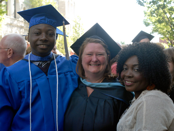 Azeez O. Salu, co-recipient of the Lewis H. Bardo Memorial Award and a graduate in computer aided drafting technology, receives congratulations from Shelley L. Moore, assistant director of career services, and his mother Janet.