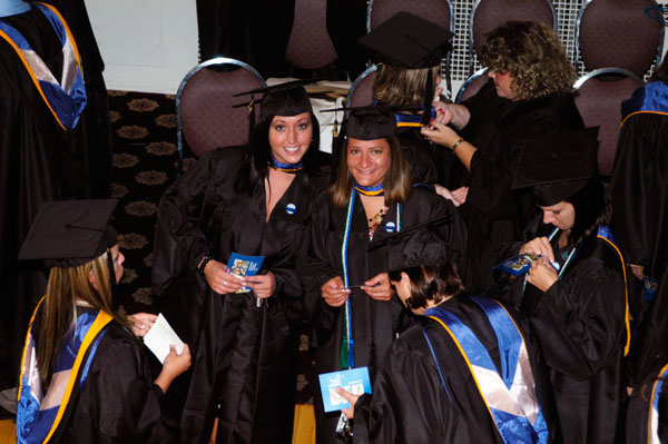Robed and ready, students spot a photographer in the balcony overlooking a Genetti Hotel ballroom.
