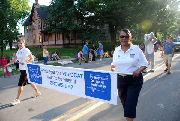 Linda J. Miller, hospitality sales manager, and Josephine S. Taylor, advertising/media relations assistant, lead the way for the Penn College parade line-up.