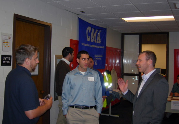 With the Construction Management Association banner proudly displayed nearby, graduates of the program gather for an afternoon of classroom presentations Friday.