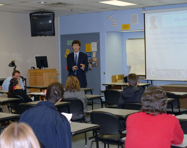 Edward A. Henninger, dean of business and computer technologies, meets with new students in a Campus Center classroom.