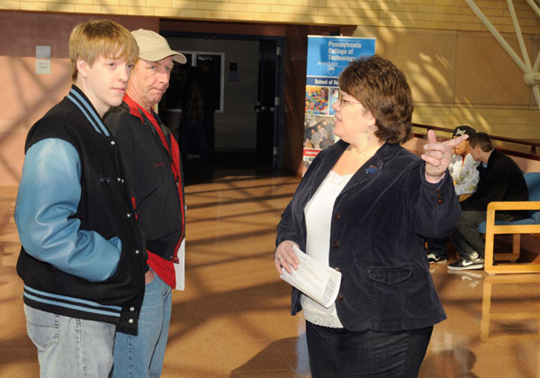 Kimberly A. Venti, a Penn College alumnus and employee, greets visitors outside the School of Business and Computer Technologies.