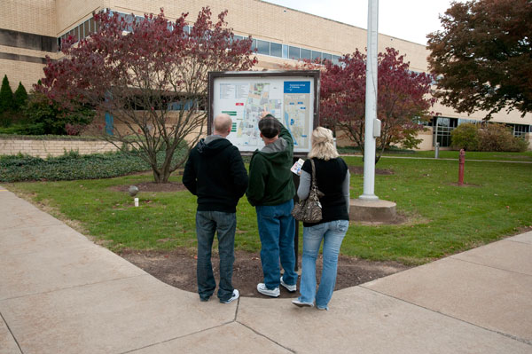 Getting their bearings, thanks to a "You Are Here" map outside the Breuder Advanced Technology and Health Sciences Center.