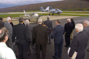 Members of Pennsylvania College of Technology's Board of Directors look at the Grumman A-6 E Intruder and the Cessna T-41B during a tour of the Lumley Aviation Center after Thursday's meeting.
