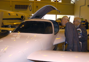 Board members Robert N. Pangborn, left, and Robert Secor check out the Velocity composite aircraft during a visit to the hangar.