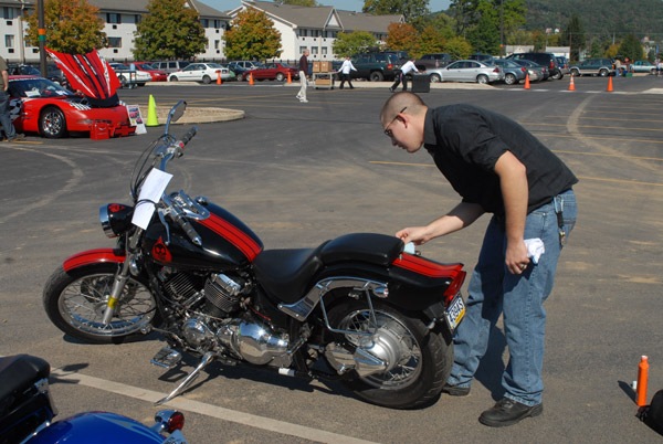 Bryann Bingaman, a property protection officer with Penn College Police, polishes his 2002 Yamaha during the Homecoming Car Show.