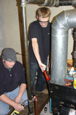 Ronald J. Button, left, and Matthew J. Kinneman at work in Watsontown.