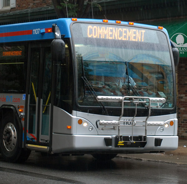 A River Valley Transit bus, transporting graduates and their families back to campus, flashes its point of departure.