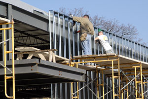 Construction workers make marked headway toward enclosing the building for winter's work.