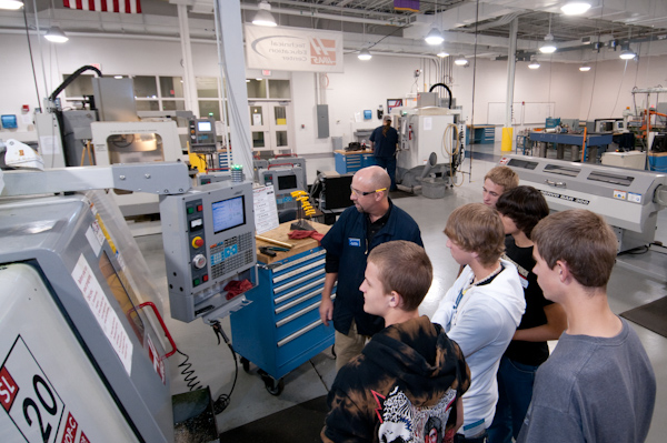 Visitors learn about computer-controlled machining from Richard K. Hendricks, instructor of machine tool technology/automated manufacturing.