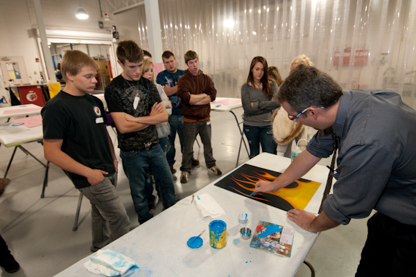 Roy H. Klinger, instructor of collision repair, demonstrates "flaming" techniques.