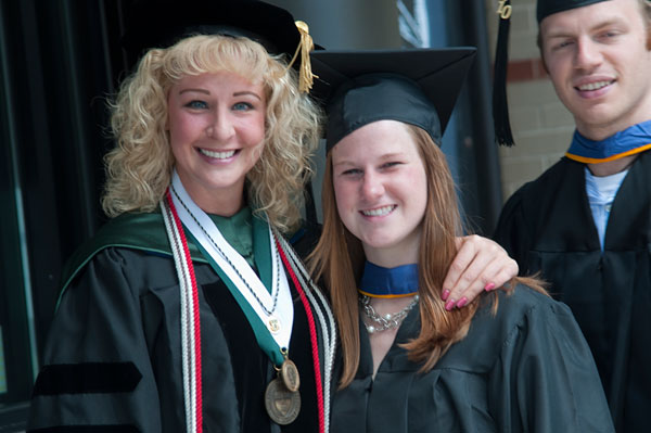 Tina M. Evans, associate professor of dental hygiene/applied health studies, accompanies students in the procession.