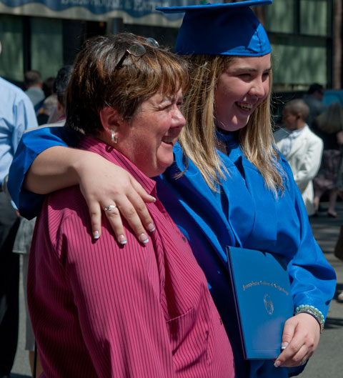 A jubilant grad shares the moment with her mom.