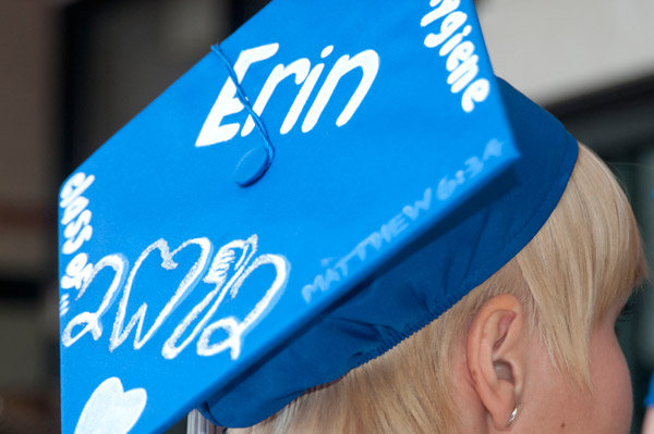 A dental hygiene graduate shows off her major on her cap.