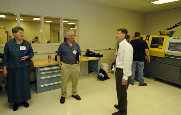 Kirk M. Cantor, professor of plastics technology, talks with Grand Opening attendees.