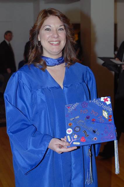Michelle M. McMurtrie, who earned an associate degree in nursing, shows off a colorfully decorated cap that combines her new profession with a festive "Ho Ho Ho" and a preview of a postgrad getaway to Las Vegas.