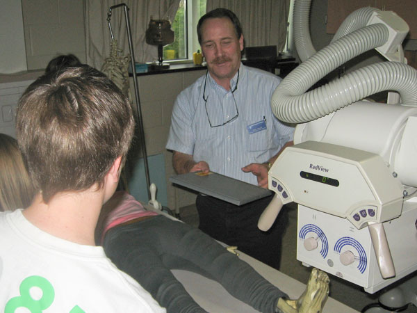 Regis L. Kohler, associate professor of radiography, leads students in taking images of a phantom patient.