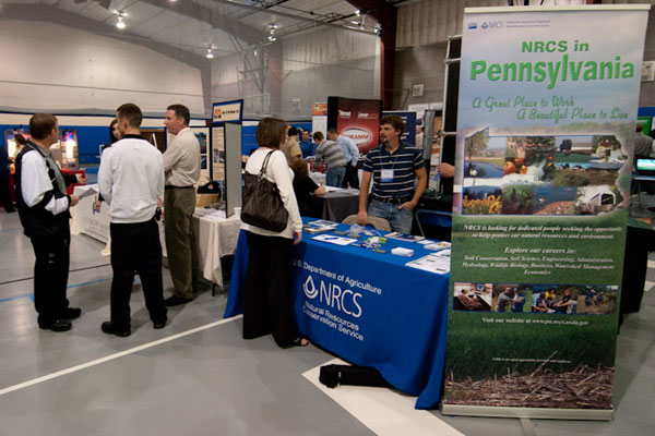 A student visits the U.S. Department of Agriculture-Natural Resources Conservation Service booth.