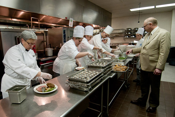 Eggers supervises a busy prep line that includes President Gilmour.