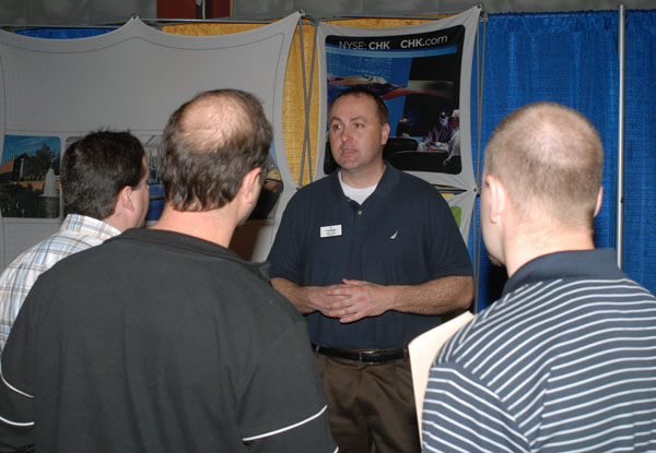 Chesapeake Energy field recruiter Mikel Lucas helps handle the crowd at his firm's booth.