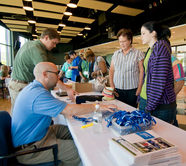 Admissions representative Salvatore Vitko (seated) and Connections Link Collin A. Zimmerman assist visitors at check-in.