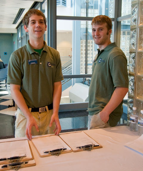 Student leaders Justin A. Ball and Steven V. Williams offer service with a smile.