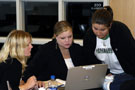 Legal assistant/paralegal students Jennifer L. West, of Trout Run (left), vice president of the Penn College Legal Society, and Stephanie A. Davies, Williamsport (center), the organization's president, explain the voter-registration process to a student in the second-floor law alcove of the Madigan Library.