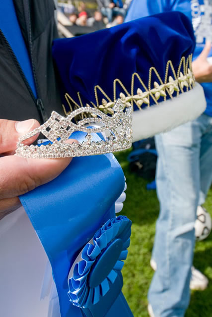 Homecoming crowns are held by Mike Stanzione, associate director of athletics, prior to Saturday's coronation.