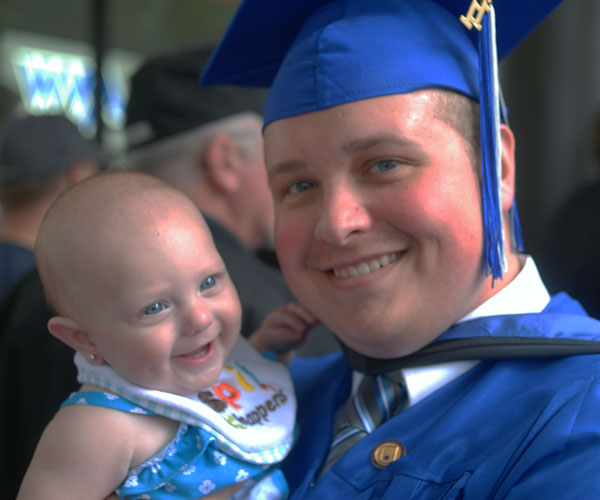 Matthew G. Barner, of Mill Hall, an emergency medical services graduate, celebrates with daughter Riley.