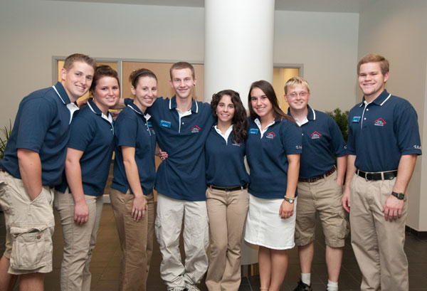 Dauphin Hall Resident Assistants stand in the lobby, ready to give tours to visitors.