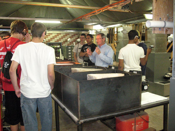 David E. Pentz, assistant professor of plumbing, explains some basic aspects of heating equipment to visiting students.