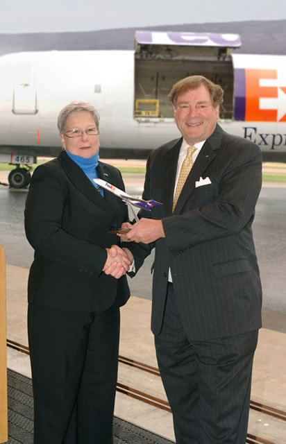 A handshake officially completes the plane's transfer from professional service to academic use.