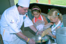Day campers add Rice Krispies to Penn College student Robert G. Steward's recipe.